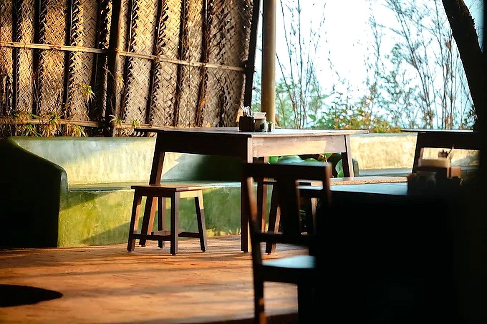 Warm evening light across the wooden tables at BĒRU Kitchen
